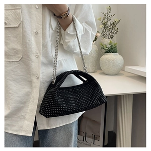Detailed macro view of black rhinestone hobo bag with a delicate silver chain strap