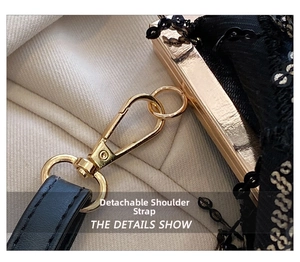 Detail of the detachable shoulder strap and gold metal hardware on black sequin evening bag