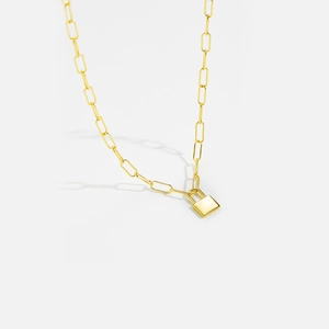 Detail shot of a minimalist golden paperclip chain necklace with a rectangular padlock pendant