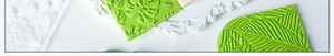 Detail showing tropical monstera leaf and floral lace embossed patterns on fondant shapes