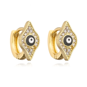 Macro detail of gold-plated evil eye hoop earrings with zircon and enamel inlays