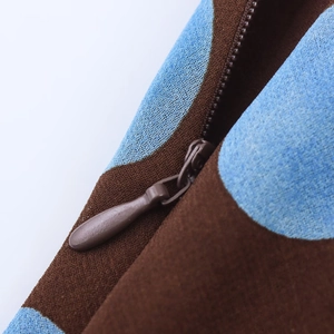 Macro detail of high-quality zipper and woven fabric texture on polka dot halter top