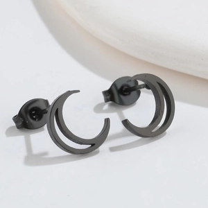 Detailed view of minimalist matte black crescent moon stainless steel stud earrings