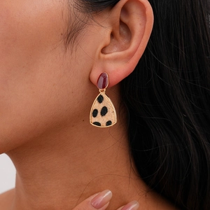 Model wearing red and gold leopard print triangle earrings with resin studs and fur texture