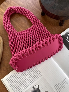 Detailed close-up of pink woven cotton tote bag featuring a durable PU leather bottom base