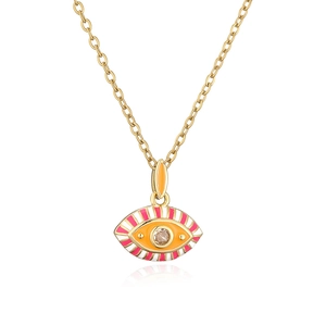 Macro detail of gold plated Bohemian evil eye pendant with pink enamel and zircon stone