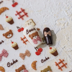 Cartoon nail art stickers with bear and cupcake motifs on matte polished nails