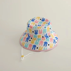 Detail of baby sun hat featuring colorful bunny prints and adjustable chin strap