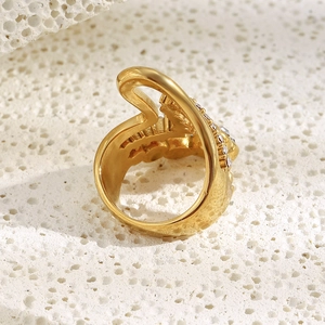 Detail of 18K gold-plated multi-layer wave ring with zircon inlay on coral stone