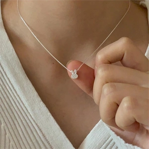 Detail of 925 sterling silver bunny pendant necklace with pavé cubic zirconia on model