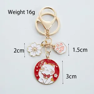 Japanese Lucky Cat metal keychain with cherry blossom and cat paw charms for bags