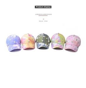 Detail showing five tie-dye baseball caps with colorful sequins and faux rhinestones