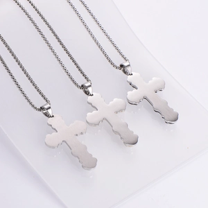 Three silver stainless steel layered cross necklaces with sleek brushed metal finish
