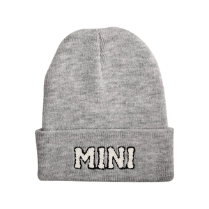 Close-up of gray knit beanie with 3D MINI letter embroidery on the folded cuff