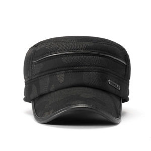 Close-up of military flat top cap showing camouflage texture and metal logo detail