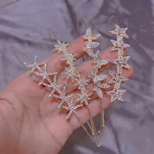Set of four thin gold rhinestone headbands with butterfly and star designs for women
