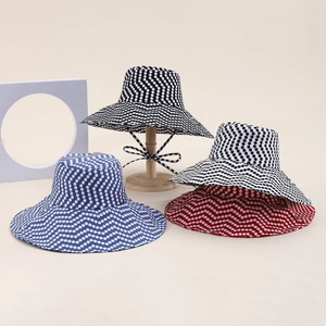 Reversible wide brim sun hat with polka dot pattern and chin strap for women