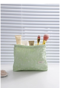 Close-up of portable floral jacquard makeup bag with brushes and skincare storage