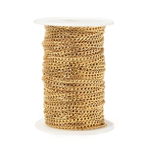 Close-up of golden stainless steel Cuban link chain on a white spool for DIY jewelry