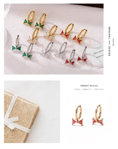 Detail showing bowknot earrings with multicolored zircon inlay on textured white fabric