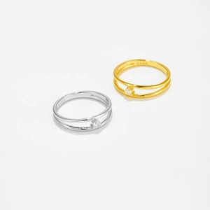 Macro detail of S925 sterling silver stamp and sparkling cubic zirconia on gold and silver rings