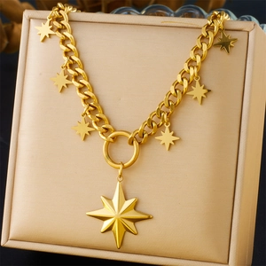 Detail of gold chunky star pendant necklace displayed on a premium beige jewelry cushion