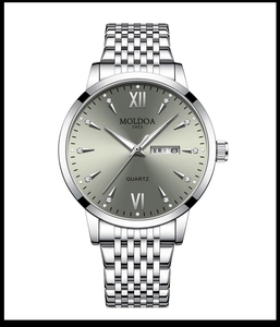 Macro detail of silver stainless steel watch dial with Roman numerals and day-date window