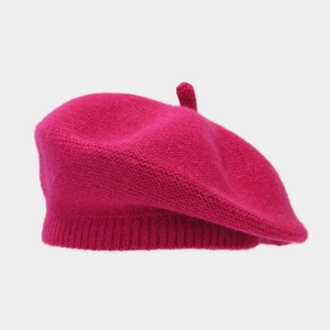 Detailed knit texture of a warm rose red rabbit hair beret with soft fuzzy finish