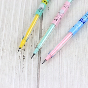 Close-up of three stackable multi-point pencils in yellow, green, and blue on a wood desk