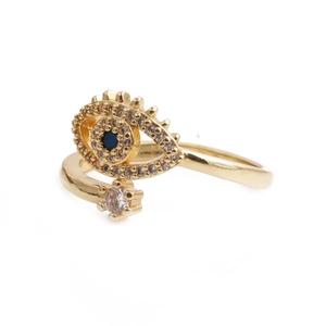 Detail of gold evil eye ring featuring blue and white zircon stones on white background