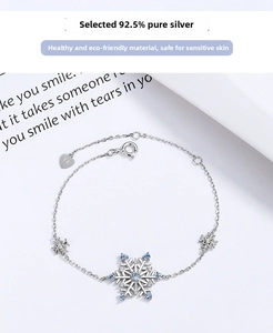 Close-up of S925 silver snowflake bracelet with blue crystals and heart logo tag
