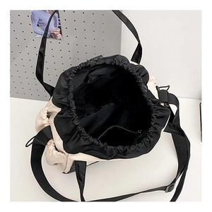Top view of spacious nylon tote bag interior with zipper pocket and drawstring closure