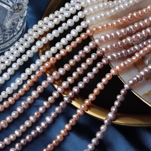 5mm natural freshwater pearls in white pink orange and purple on a luxury silk background