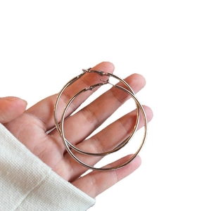 Minimalist silver circular hoop earrings in a classic large round metal design for women