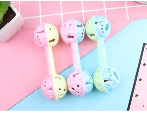 Detailed view of three macaron-colored baby rattles with textured easy-grip handles