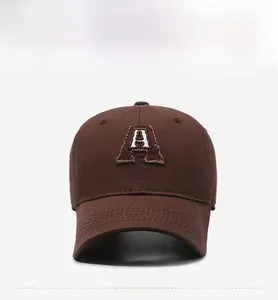 Detailed embroidery of letter A on dark brown cotton baseball cap in retro style