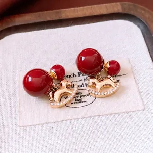 18K gold plated rocking horse earrings with deep red beads and zircon accents