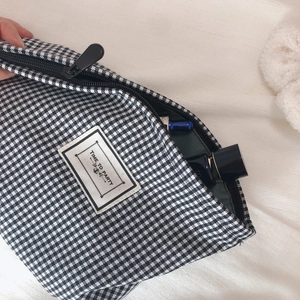 Classic black and white houndstooth makeup bag with Time to Party patch and zipper