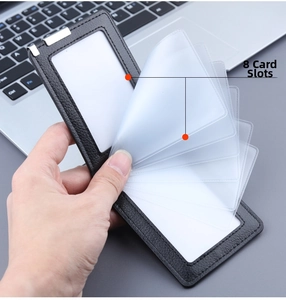 Close-up of black litchi grain leather card holder with 8 clear PVC card slots and metal clip