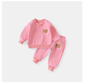 Detailed view of pink fleece toddler tracksuit with cute brown teddy bear embroidery
