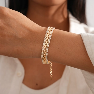 Detail of gold-plated triple-layer bracelet with clear zircon pavé and square links