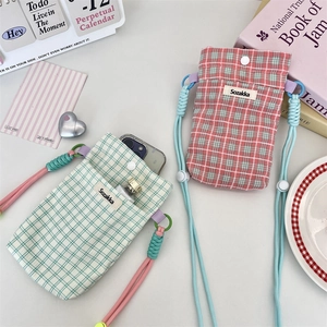 Detail of plaid fabric crossbody phone bags showing interior storage for essentials