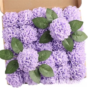 Detail of faux purple dahlia and hydrangea flower heads with green leaves in a kraft box
