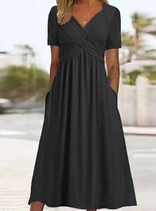 Detail of a black V-neck short sleeve dress with side pockets and soft fabric texture