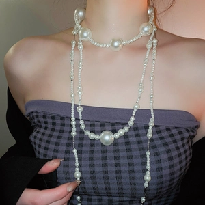 Close-up of layered French vintage pearl necklace showing glossy multi-size pearls