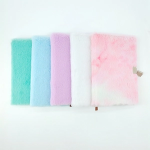 Detailed row of plush A5 notebooks in pastel colors featuring a metal lock and soft texture