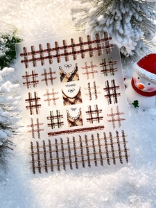 Detail view of YT6460 Christmas plaid nail stickers with bows and French tips on snow