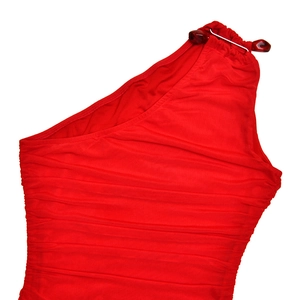 Detail of red one-shoulder dress featuring pleated fabric and decorative metal buckle