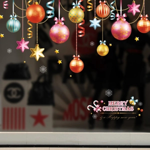 Detail of Christmas window clings featuring colorful ornaments, stars and holiday text