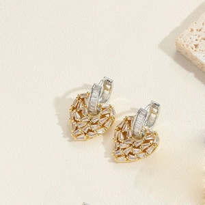 Detail of 14K gold plated heart earrings with pavé set crystals and two-tone finish